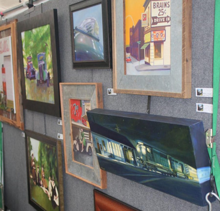 Various paintings are on display in a tent located at Art in the Park in Afton.