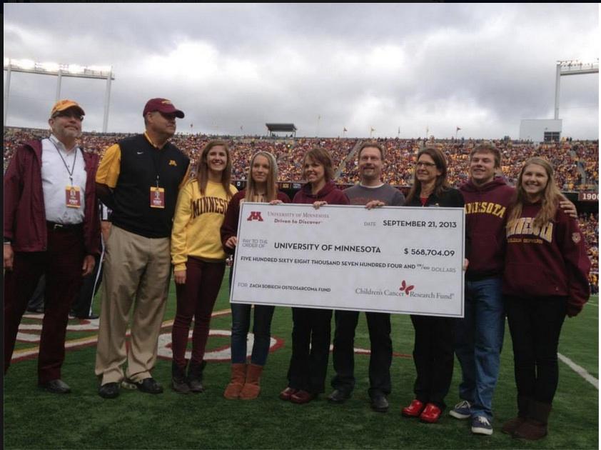 Sobiech family and friends present check to the University of Minnesota Medical Foundation.