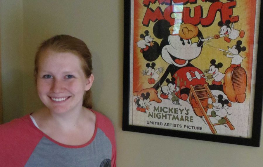 
Senior Laura Serier posed by one of the many posters in her Disney themed basement.