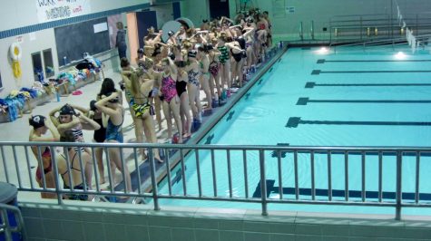 The girls swim team gets ready for their State True Team meet to start.  In a True Team swim meet, every member of the team participates in one event to try and gain points for their schools team.  This is the most important swim meet of the entire year.  