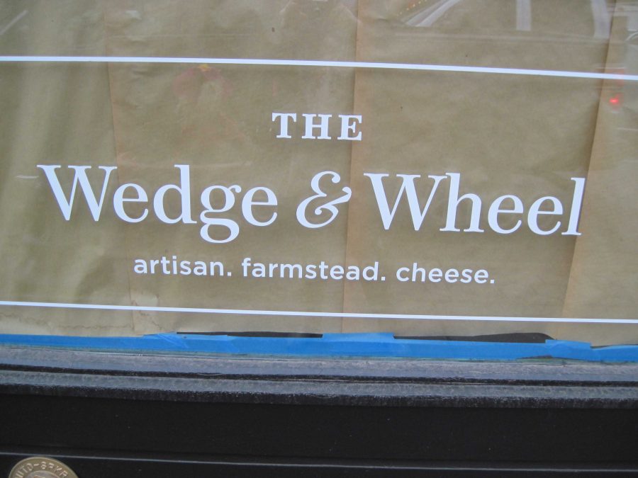 
Owner of the Wedge and Wheel Chris Kohtz poses in front of his new, unopened cheese shop in downtown Stillwater.