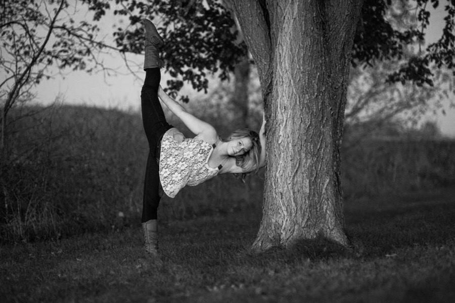 
Erler jumps elegantly to pose for a photographer while showing off her dance skills. These skills have been honed in by her many years of dancing.