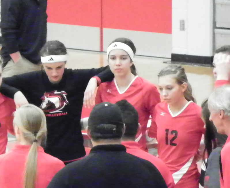 The+Varsity+volleyball+team+huddles+up+as+they+end+another+successful+season+with+middle+hitter+Stephanie+Dietrich+%28%E2%80%9914%29.+From+left+to+right%3A+Stephanie+Houle+%28%E2%80%9914%29%2C+Stephanie+Dietrich%2C+and+Janae+Momchilovich+%28%E2%80%9914%29.+Dietrich+will+be+playing+volleyball+at+Michigan+Technological+University+this+upcoming+fall.