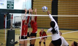 
Evans and teammate go up to block an opposing spike during a late season game against Roseville. Evans great leadership showed after stuffing this spike 