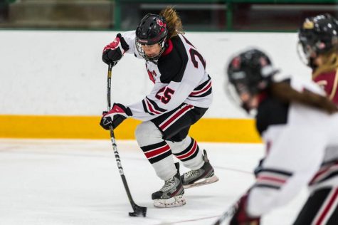 Senior girls hockey captain Jane Vezina shooting a slapshot agaisnt opposing team Lakeville.
