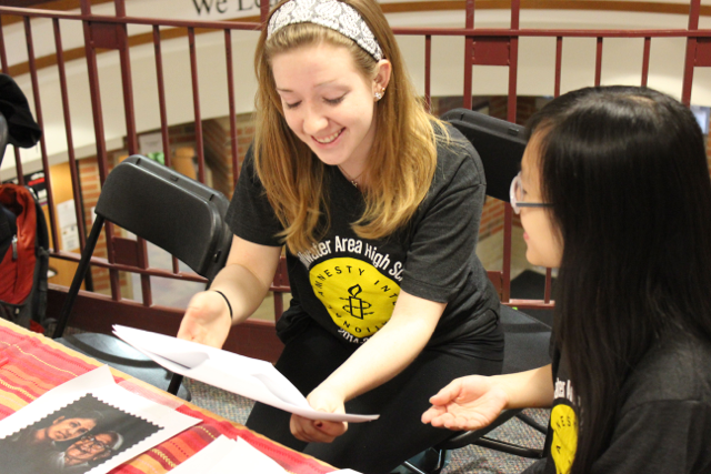 Junior Erica Oren, discusses the Human Rights Day Petitions with another Amnesty club member.  The petitions are to help people all around the world understand their human rights and they make sure that all humans receive those rights.