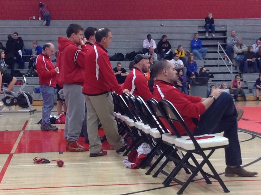 Junior Gavin Keogh and the wrestling coaches intently watch while a fellow team member has his moment on the mat. Gavin Keogh typically wrestles, but did not at this meet due to injury. He has been in wrestling since he was 8 years old and he currently one of the wrestling captains for the Varsity Team.  There has always been motivation from my coaches, and my dads been a driving force, too said Keogh.