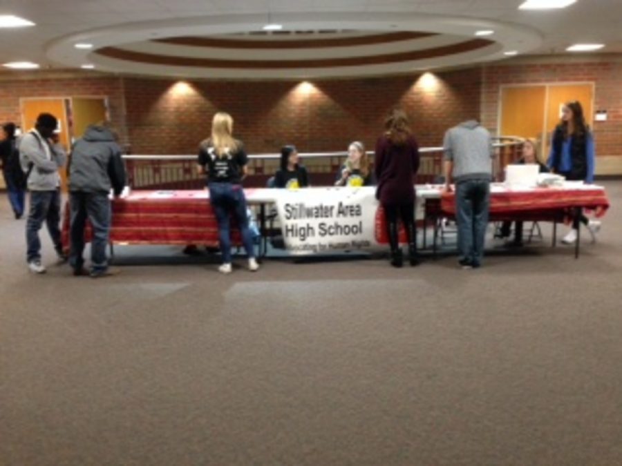 Members of the Amnesty International club sit at a table in the upper rotunda for SAHS students to ask them questions about human rights and also give students the opportunity to sign petitions for human rights.