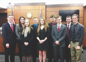 Pictured are senior Nick Sabin, senior Rachel Hartwig, senior Holly Fena, junior Justin Hannasch, junior Natalie Sims, senior Alex Eitzman, senior Alexander Screaton, senior Mitchell Sell, and senior Adam Johnson. The relationships formed through Mock Trial will last much longer than the time they spend together in the courtroom. Junior Natalie Sims said, “I’m so sad to say goodbye to the seniors. They were so helpful with everything. You become so close to these people and they are almost like a family and it’s weird not seeing them everyday now. I could always count on them if I had any problems with Mock Trial or just personally. It’s going to be hard to say goodbye to all of them.” 