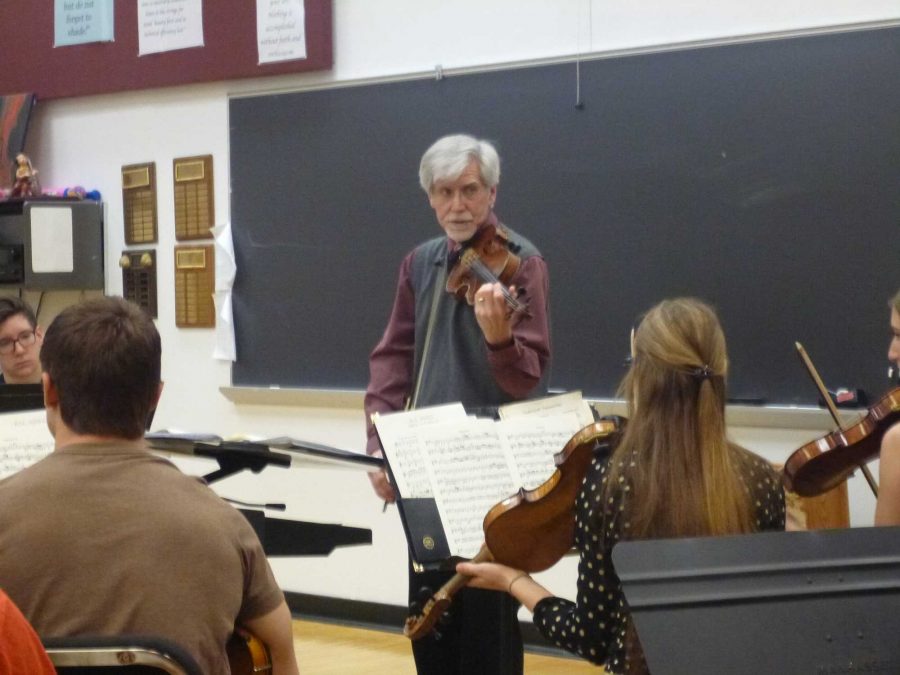 Orchestra Director Jerry Jones explains a passage while holding his violin. Usage of metaphors and analogies help students to see and feel what the music is asking of them. “I will miss being important to whom I think is the most exciting generation on the planet. Because everything is What can I learn, how can I do this, where am I going, I’ve got my life ahead of me and I want to make something of it. It’s a tremendous privilege, I will miss it more than anything else. The medium I have used over the last 39 years is music. My kids want to be here, they are kinesthetically involved, they are emotionally involved and they are cognitively involved, I’m able to deal with the full complete student. There is no greater privilege on the face of the earth, than what I’ve been able to experience,” said Jones.