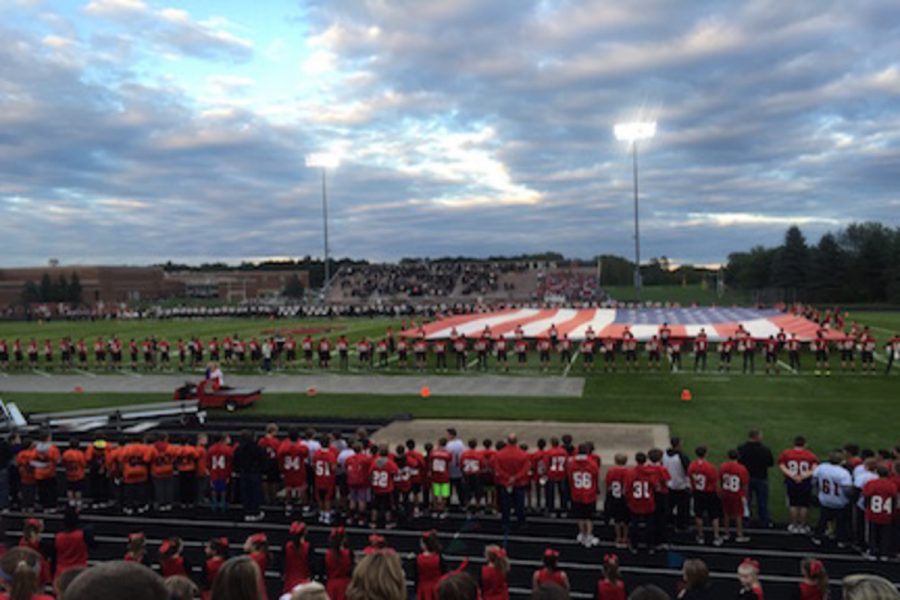 Photo by Allie Langness
Before the game, a ceremony was held to honor the local first responders throughout from throughout the community. A flag extended across more than half of the field and a flag was hung on the north end of the stadium by two fire trucks.