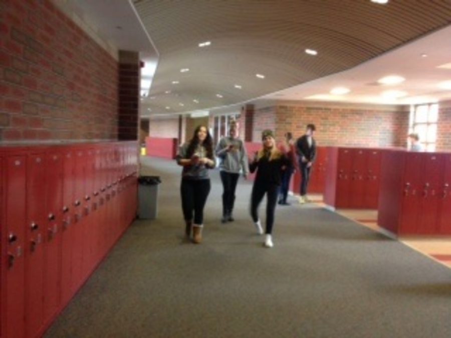 Newspaper students Rachel zingraf, Tiana meador, Rachel Harrmain, Chris Gilleo and Brian japp walk down the hallway in search of good photos to take. Several of the students had not known how to take an establishing shot so they were on their way outside to take one of the school.