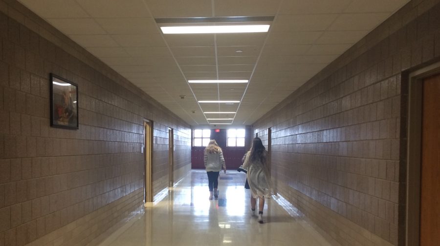 Walking through SAHS halls, Sarah McCarthy and Grace Donner are hard at work on a newspaper assignment.