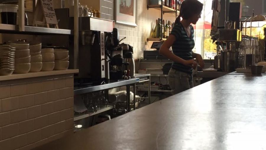 Picture of Hallie Chasensky cleaning the coffee station. Picture taken by Joslyn Reiche.