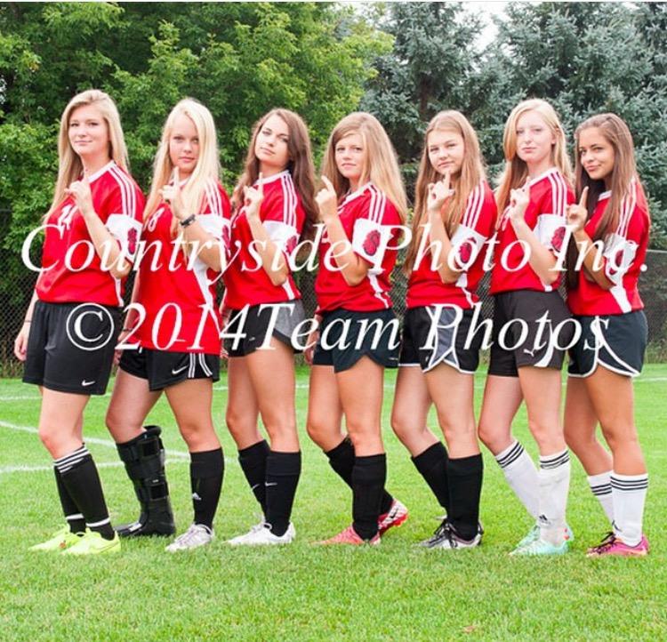This photo is the 2014-2015 Stillwater Area highschool girls’ B squad soccer team.  The photo perfectly captures the girls coming together and taking a team picture.     