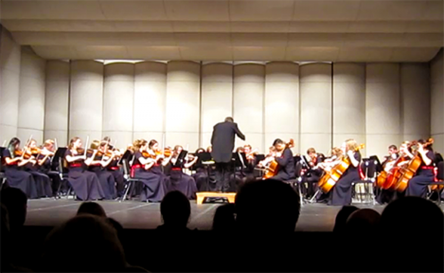 Parents and family members all sit and watch as the Concert orchestra plays and Sawyer conducts for the first time.
