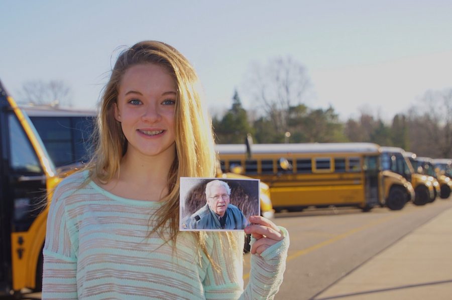 Taylor Gregg stands in front of the buses that her grandfather used to drive before he passed away. “I was probably in fourth grade and I would talk to him all the time on the bus,” Taylor says.
