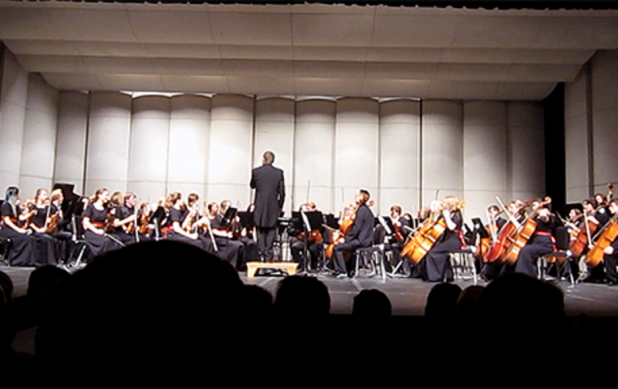 As Sawyer walks on the stage with the Concert orchestra for the first time he takes a second to give them the beat to begin playing. 