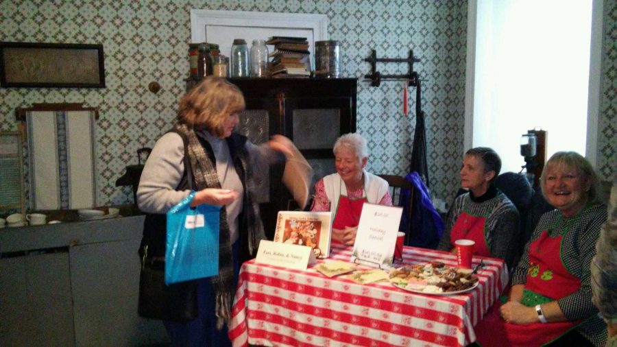 Three women, including Robin Gullickson, sit behind a table piled high with their homemade cookies and the recipes that will teach readers how to make them. We have only had the book out for a year and it was never really our intent to publish it. It has been fun though, says Gullickson, above far right.