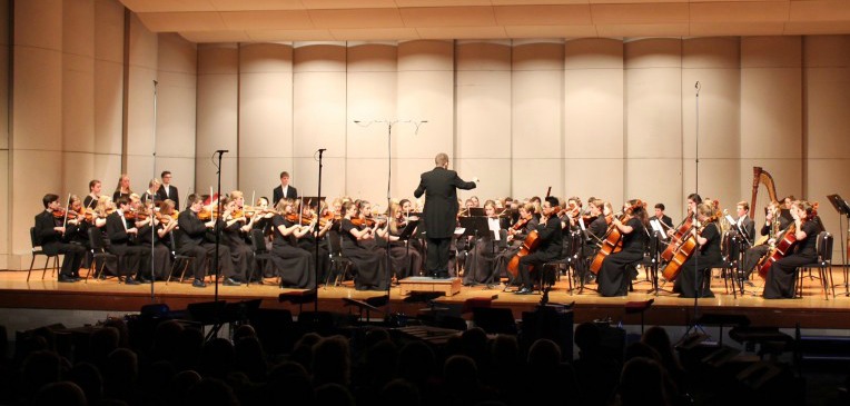 Stillwater Orchestra performing a symphony at the Winter Concert, As a student, lots of focus is required to be prepared for the winter concert. In order to be ready on time, 100 percent focus and concentration is necessary. It is also super fun getting ready for the concert! You get to make fun holiday music with great people! says Vogel.