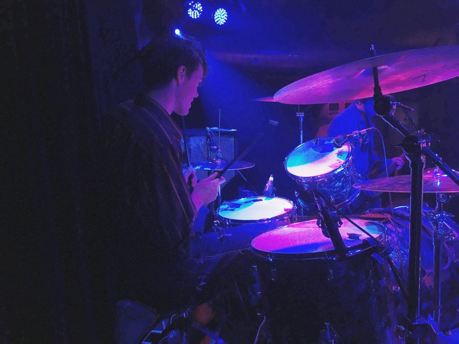 Shown is sophomore Evan Cambell playing his drums during him and his bands show in a local bar. The band performed two separate acts that lasted throughout the night 
