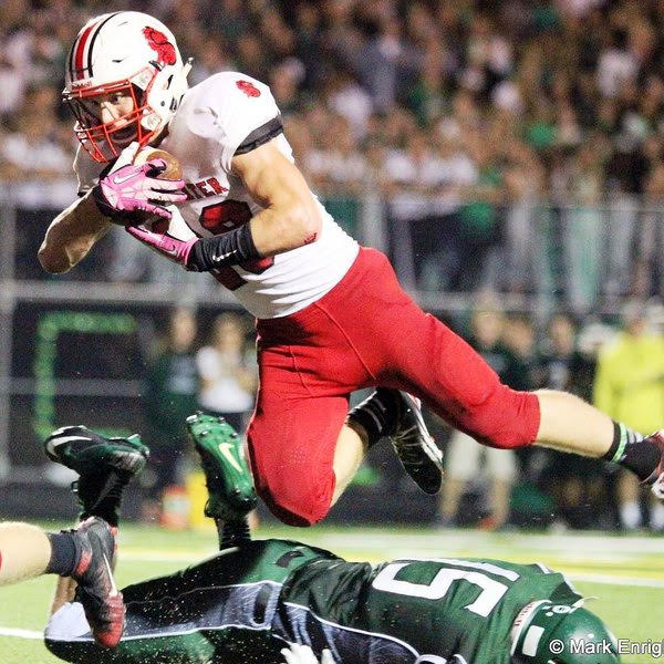 Wagner takes flight Friday night and lands on his feet to get a needed first down in the red zone v.s. Mounds View. “It was the community that we shared as athletes that, while not lost after the season, is not the same as it was during our season, says senior Stephen Wagner.