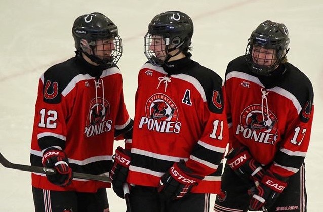 Juniors Thomas Bruchu, Noah Cates and Brody Swanson sharing a laugh during a game against Maple Grove. The junior boys are a close knit group who have been playing hockey together their whole lives. Weve been laughing on and off the ice since squirts, Bruchu says.