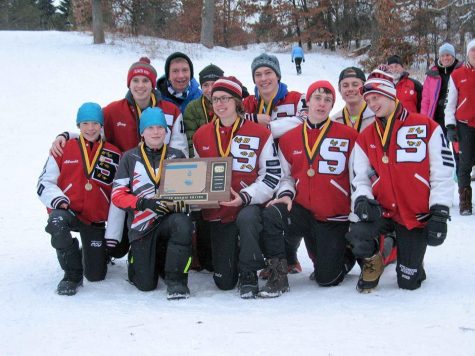 The Varsity boys team triumphantly pose with their first place plaque after their win at battle creek this past January 26th. (Front row left to right) junior Josh Albrect, 7th grader Caden Albrect, junior Noah Kneeskern, junior Shad Kraftson, junior Nolan Noer (back row) junior Colin Gray, sophomore Jack Lange, sophomore Brian Olson, senior Seth Cattanach, senior Sam Hanson. We have to go and prove that ranking to ourselves and to the state - but I know were capable of winning the state title, senior captain Seth Cattanach says.