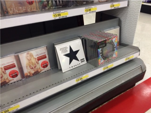 The Blackstar album sits on the shelf among other albums. The CD version sold out on Amazon after its initial release. The CD medium is still popular, even with the fact that digital music is available at the click of a button.
