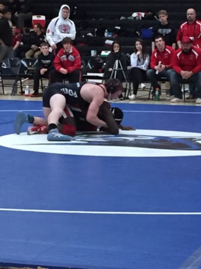 Junior James Huntley looks to be victorious as he finishes the pin on an opponent.  There are lots of complicated moves wrestlers have to know and perform if they want to be any good. says Huntley.