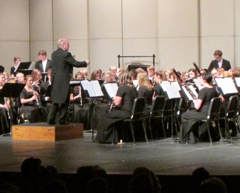 Dennis Lindsay conducts his band at the recent Wind Symphony concert. All eyes are on him as they play. We have to stay very focused during the concert so that we can play our best, junior Joe Weber says.