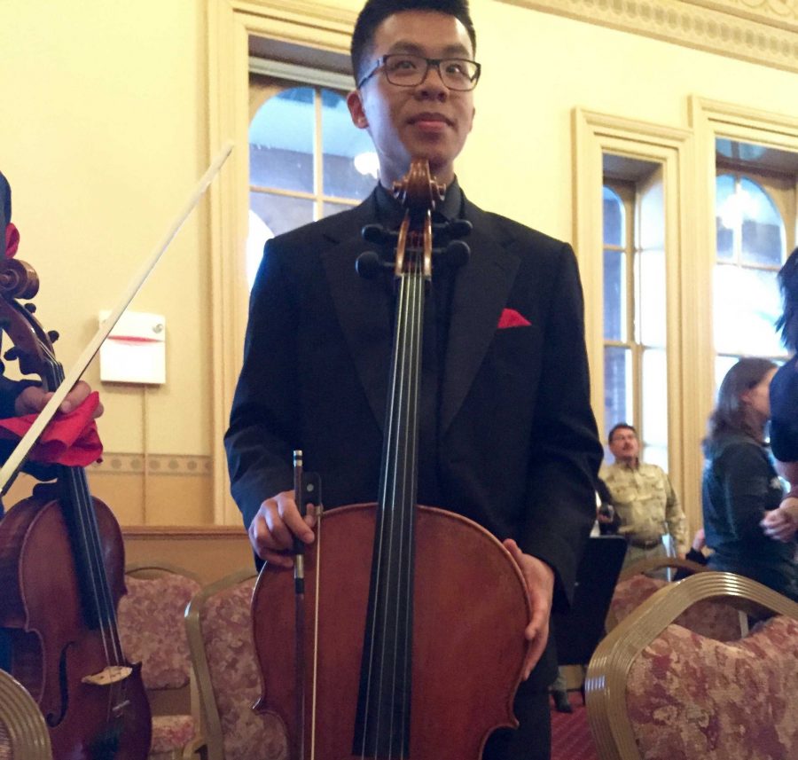 Senior Jonathan Luk stands by his instrument following the concert.  The concert was full of music performed by students.  “It was fun seeing my fellow classmates and friends perform and do well,” junior Jack Leach says.
