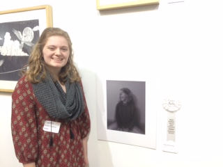 Senior Caitlin Rademacher is surrounded by lots of beautiful pieces. Her own work of art, the small black and white photo beside her, impressed many visitors as well as the judges of the competition. She received an award and a cash prize for her work. “I feel like it’s a little cliche to say that it feels good, but really, it does. I’m proud of what I made and i’m proud to be here,” Rademacher said. 
