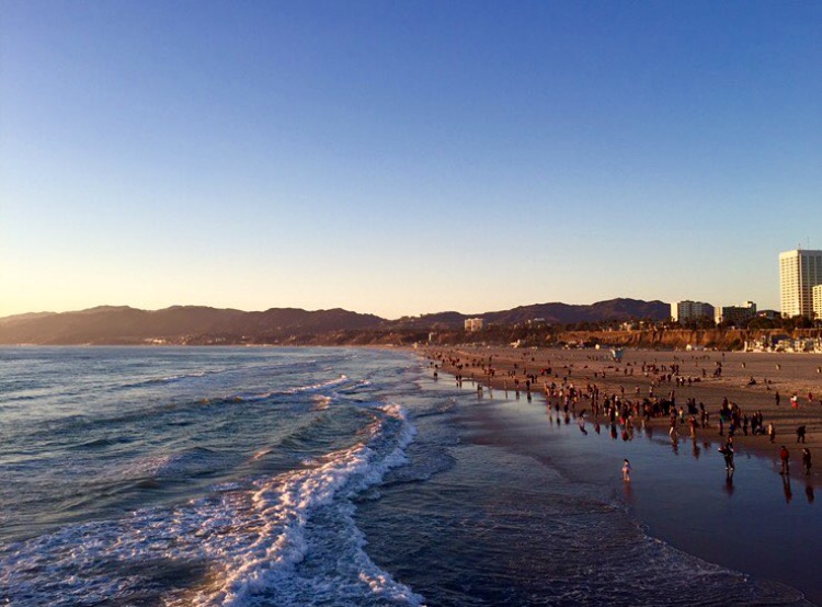 People enjoying the beach and Pacific Ocean at the Santa Monica Pier in December 2015. 