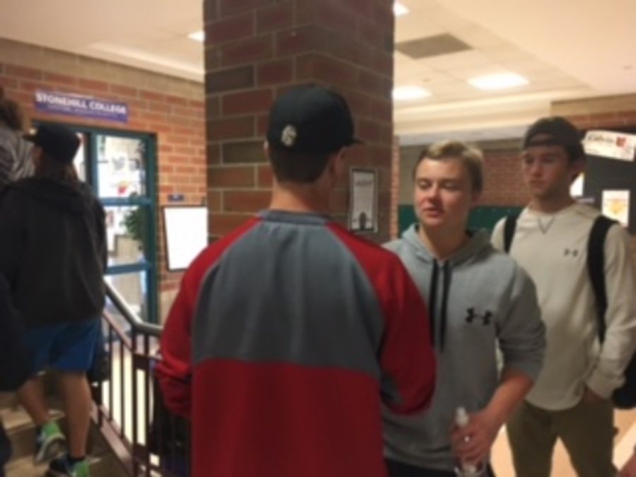 Juniors Brice Hafemeyer and Eric Larson talking in the hallway, both wearing the athletic look. Brice Hafemeyer says, “Athletic clothing is much more comfortable and easier to focus in.”
