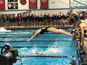 A girls swim and dive team member jumps into the pool at SJHS. “It’s exciting and really cold,” Junior Emily Weiss says about the moment you hit the water during the beginning of a race.