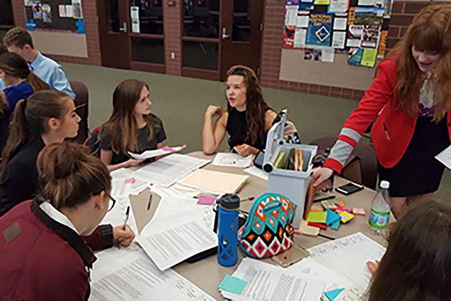 Junior Sophie Rondeau (middle) explains techniques to some novices at a Debate tournament. “My favorite part of debate is definitely the people on the team! They consistently make tournaments and practice more fun, and each person brings something unique to our team. I also enjoy researching our topics, and I feel like learning about both sides really helps me develop my own stance on each issue,” Rondeau says.