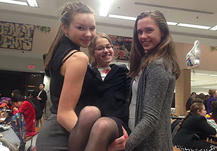 Junior Sophie Rondeau (left), Junior Anna Lee (middle), and Junior Danielle Snow (right) at speech. “Speech offers a ton of different categories so I get to choose what I speak about. Also, speech really helps with general speaking skills and I feel like my presentational speaking has improved a lot by joining the Speech team. The same goes for Speech as with my other activities: the people make the experience so enjoyable,” Rondeau says.
