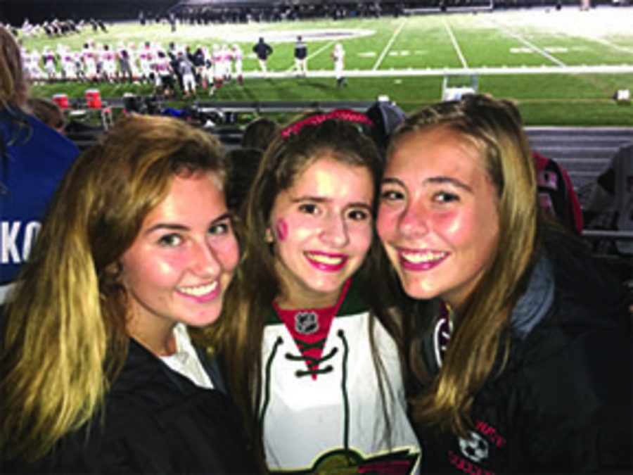 Juniors Danielle Keran, Michelle Strodthoff and Ellen Lenertz getting ready to watch a great football game. Strodthoff says,"I wouldn't want to go to the game with anyone else." 