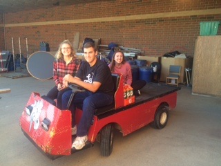 Photo By Thomas Johnson - Managers headed out to practice on the football cart. Senior Josh Stivland (driving the cart) says, The cart is an easy way for us managers to get around the practice so we can do what Coach LaBore needs in a quick manner.