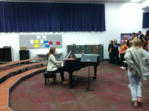 The bell has rung, and Mrs. Mitchell begins taking the students through Warm-ups, to prepare everyones voice for a rehearsals worth of singing. She has her own style of running the choir through warm-ups, usually including some variation of a scale or pattern to both prepare students voices and their minds to learn. Her reason for warm-ups is not only to prepare, but to make sure everyone knows what they are doing, whether it be singing in tune or following along.