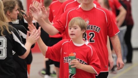 John Lindeberg #2, is seen here giving high fives after finishing an intense game. John loves playing on the Stillwater adaptive soccer team and representing the Stillwater Ponies. It is so much fun to play with my friends, John Lindeberg says.