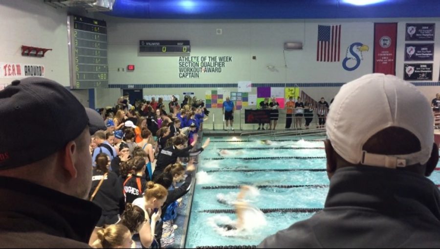Fans watch as girls compete in the section meet on Nov. 10 from the packed stands at Stillwater jr. High school as students cheer on their teammates in the pool. It gives a burst of energy when you hear the fans screaming and your teammates cheering you on, said sophomore Asia Nueman.