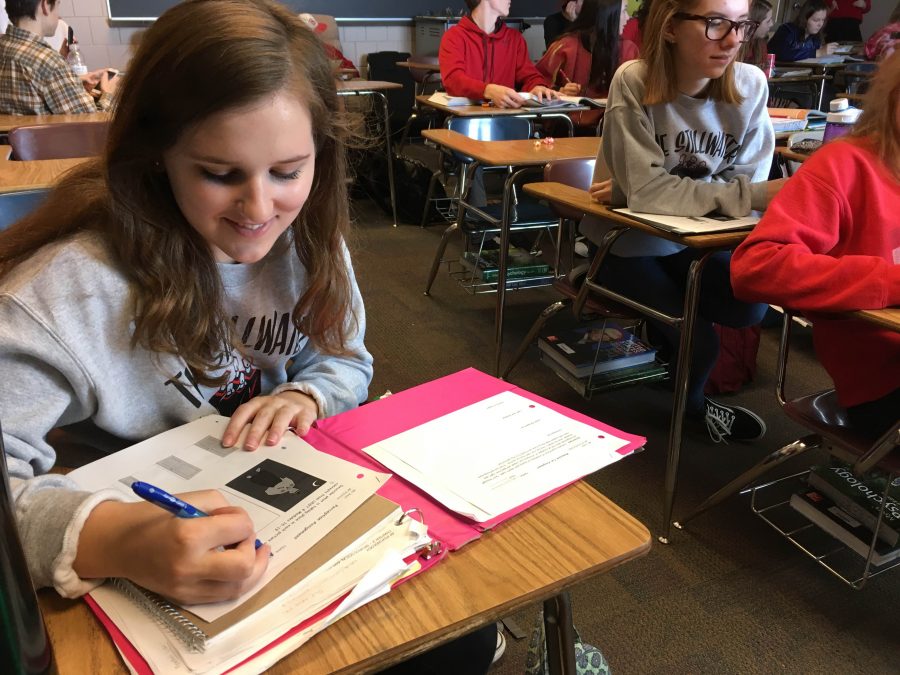 Camyrn Davis, senior and NHS president, works on classwork. If she has an idea, she’ll bring it up, and she’ll definitely follow through, and I saw that with Student Council too, but Mr. Engler has been a really awesome adviser, and really reliable and a great person, Davis says.