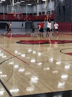 Photo by Bella Anderson-
Senior Lucas Braun takes a three during a game during Open Gym.  "Open gym in the morning is really for those who want it enough to wake up at 5:45 voluntarily to get better,"  says Shikenjanski.