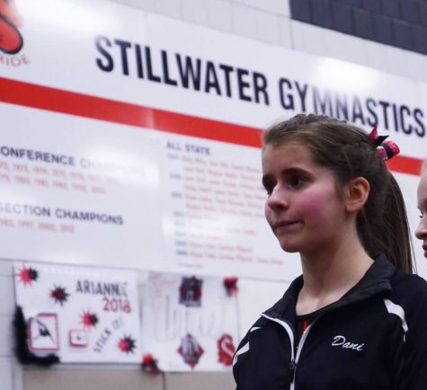 Junior captain Danielle Keran before the meet in her warm ups. Keran says, “We were all together as a team getting ready to go, we were a little nervous because it was the first one, but we were also excited.”