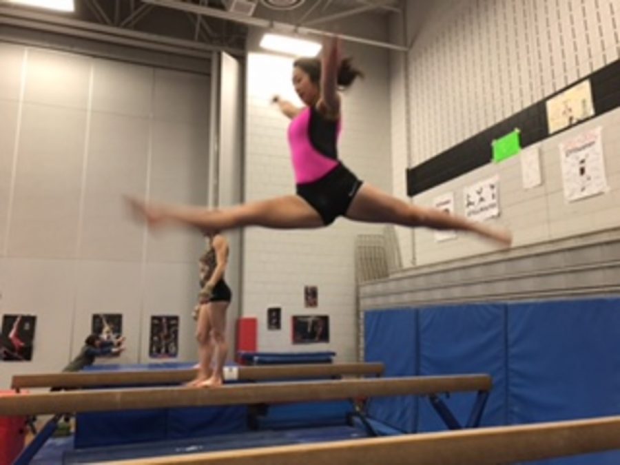 Sophomore Sami Chang working on the beam during practice. Chang says, “Practice makes perfect, and Im hoping to be perfect for the next meet.” 
