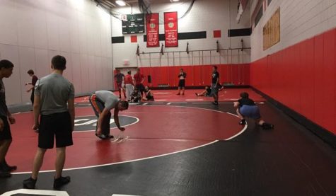     The wrestling gym of the Stillwater Ponies, where the guys look to keep improving and continue winning after falling short in the section championship. Wrestlers of all grades stretch and warm up for a successful practice session. “Our time in the practice gym is very important. A lot of wrestling is moves that you have to try over and over again to get perfect,” sophomore captain Will Harter says. (Anthony Alvarado)
