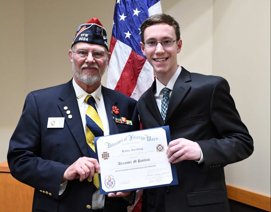 This is a photo of Alexander Pavlicin accepting the first place award in the Woodbury VFW Voice of Democracy Scholarship Program. 
Pavlicin says, This past Friday I won 1st place in the Woodbury VFW Voice of Democracy Scholarship Program, for the second year. This is also where I gave my speech “My Responsibility to America.”