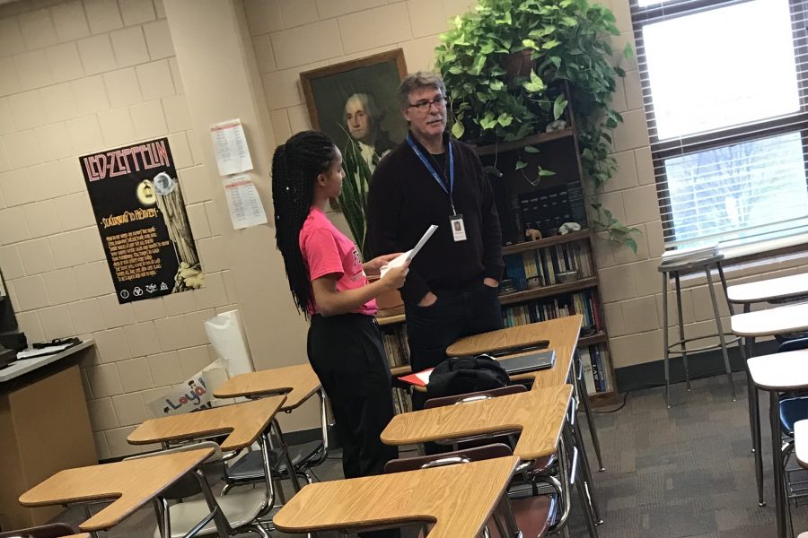 “Helping Hand”
 Kaul offering assistance in the classroom to junior Ebony Simpson, who asked a question during his fifth hour U.S History course.
“I try to answer questions in a way that a student can remember,” Kaul says.
Photo by Sam Johnson